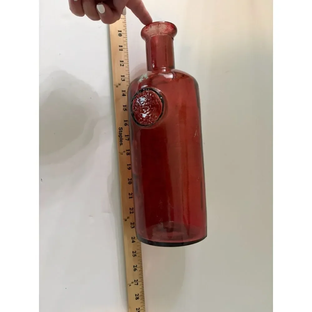 vtg ruby red glass bottle with circular medallion